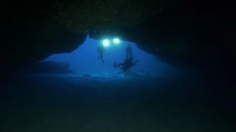 Divers with torches enter in a cave, Ustica, Sicily, Mediterranean sea Stock Footage 126718962
