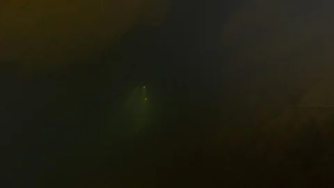Divers towards camera lights up the dark cave, Risorgenza Amaseno, Italy Stock Footage 109054055