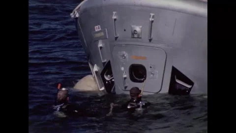 Divers waiting Apollo 8 backup crew to exit command module water egress training Stock Footage 271518588