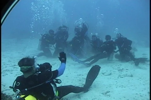 Divers waving hands underwater Stock Footage 125044