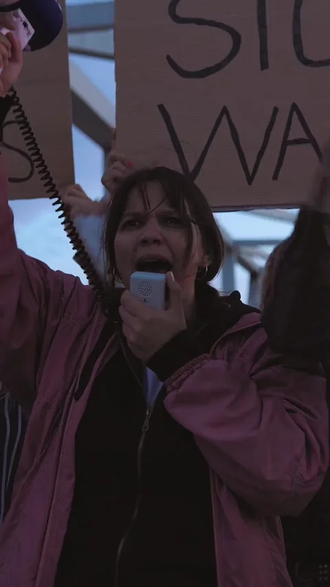 Diverse activists protesting against war with banners and megaphone outdoors Stock Footage 318408560