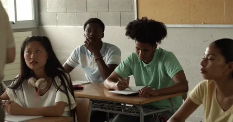 Diverse adolescent students in class listen to the teacher. School in Spain 库存影片 157351183