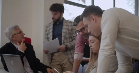 Diverse age group of people working together on a tablet pc Stock Footage 233451389