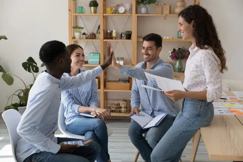 Diverse ambitious teammates find solution, make agreement give high five 스톡 사진