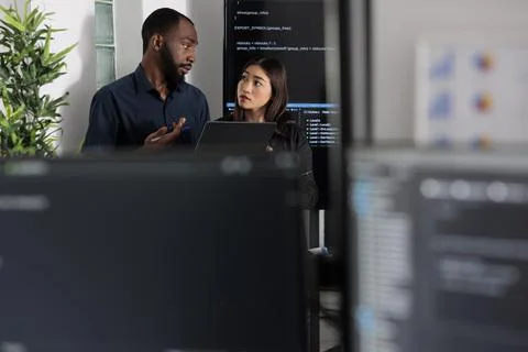 Diverse app programmers looking at algorithms artificial intelligence Foto stock