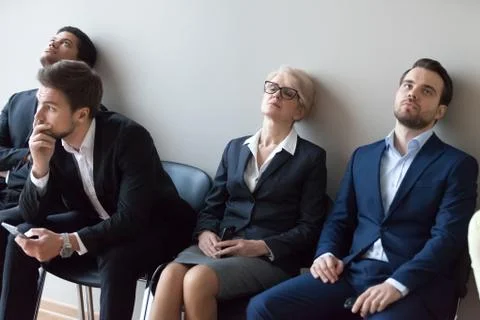 Diverse applicants getting bored in queue waiting for job interview Stock Photos