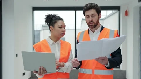 Diverse Architects Collaborate on Building Plans in Modern Office Stock-Footage 308439086