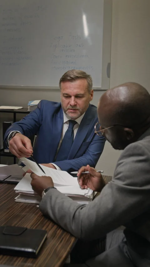 Diverse Attorneys Discussing Documents while Inspecting Case Evidence Stock Footage 323709820
