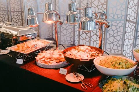Diverse buffet with various dishes on the serving table at a celebration event Stock-Fotos