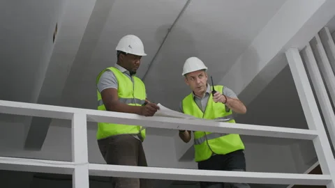 Diverse Builders Working Together at Indoor Construction Site Stock Footage 329618797