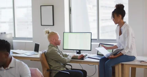 Diverse business people discussing with computer in creative office Stock Footage 337399349