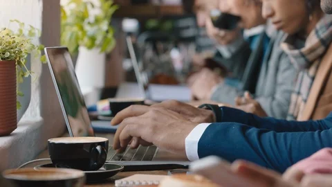 Diverse business people hands using laptop computers in busy cafe bustling with Stock Footage 103471853