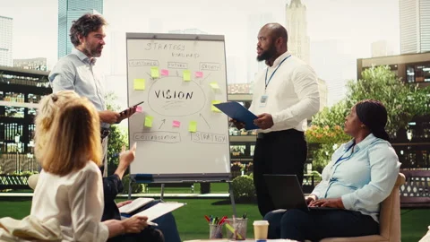 Diverse business presenters explaining vision board with sticky notes Stock Footage 338381252