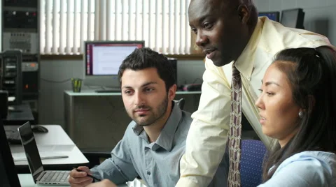Diverse business professionals in modern office at computer Stock Footage
