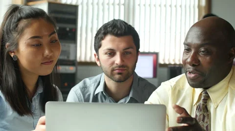 Diverse business professionals in team meeting at computer Stock Footage