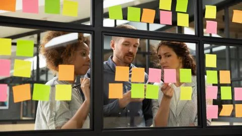 Diverse business team brainstorm on project strategy with sticky notes Stock Photos