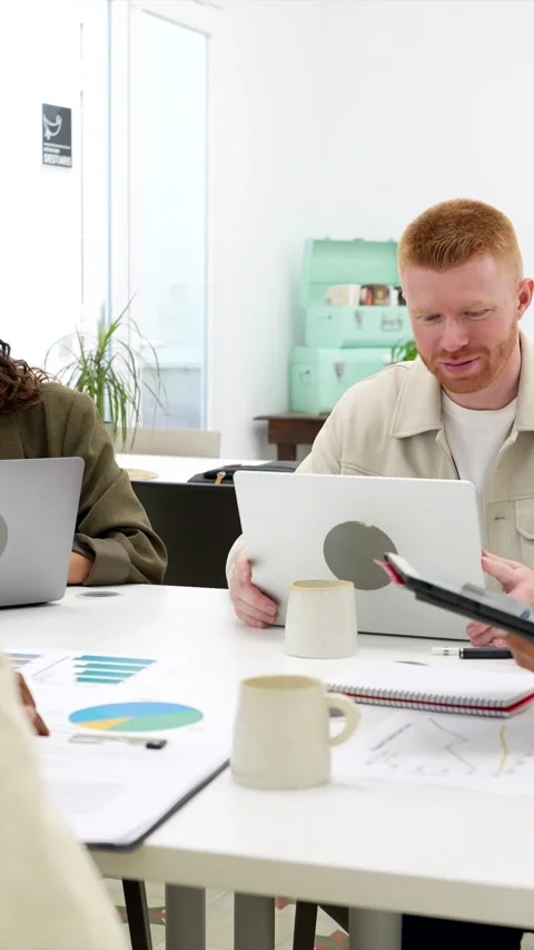 Diverse business team collaborating during meeting in modern office Stock Footage 318210030