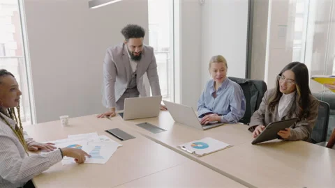 A Diverse Business Team Collaborating Effectively in a Modern Office 動画素材 307496084