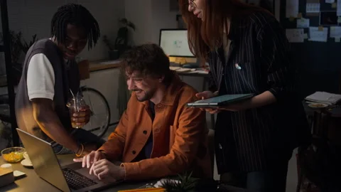 Diverse Business Team Collaborating Late on Laptop in Office Stock Footage 338413348