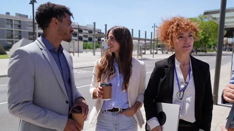 Diverse business team discussing projects during outdoor coffee break Stock Footage 336659689