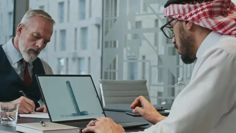 Diverse Businessmen Analyzing Skyscraper Design at Office Stock Footage 304314672