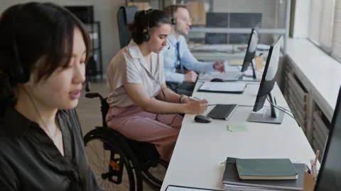 Diverse Call Center Team Providing Remote Support Using Headsets and Computers Stock Footage 335758053