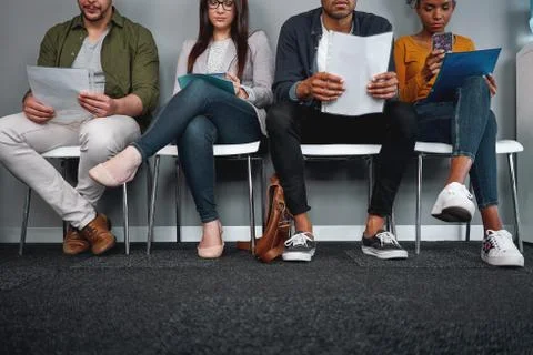 Diverse candidates sitting in queue with their cv at office expecting their turn Stock Photos