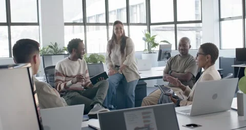 Diverse casual team reacting to notebook flip for review, tablet user showing Stock Footage 342298410