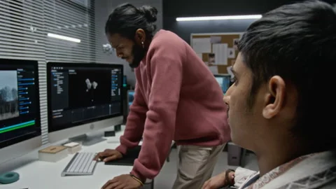 Diverse Cgi Artists Reviewing Visual Effects on Computer Stock Footage 348376759