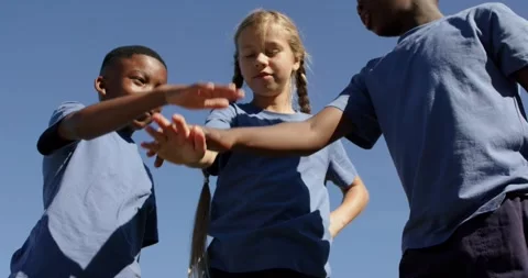 Diverse children in blue tops stacking, tapping hands when girl checking palm, Stock-Footage 344253954