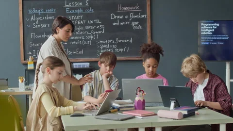 Diverse Children Learning Programming with Teacher in Robotics Class Stock Footage 339193783