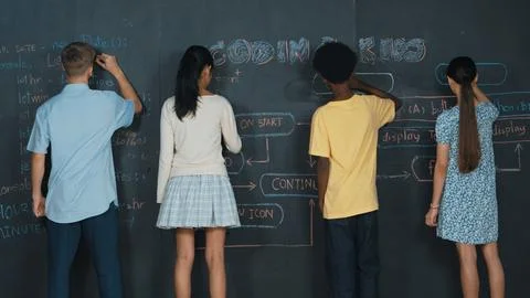 Diverse children planning to code program by using blackboard. Edification. 库存照片