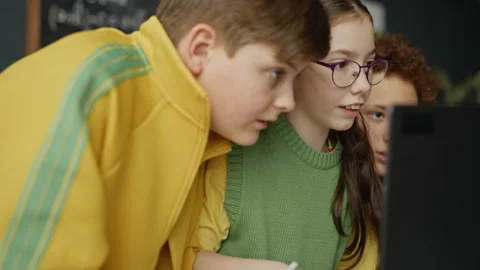 Diverse Children Using Laptop for Group Project in Classroom Stock Footage 340548631