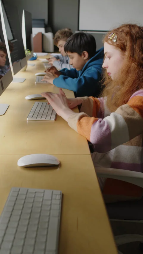 Diverse Children Writing Code on Desktop Computers in Class Stock Footage 278121062