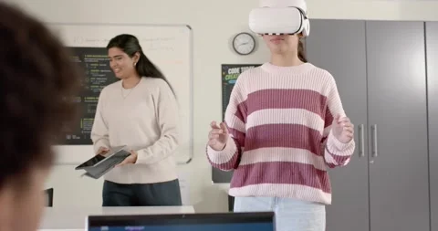 Diverse class seeing teen using VR-headset for study while peer placing tablet, Stock Footage 341063496