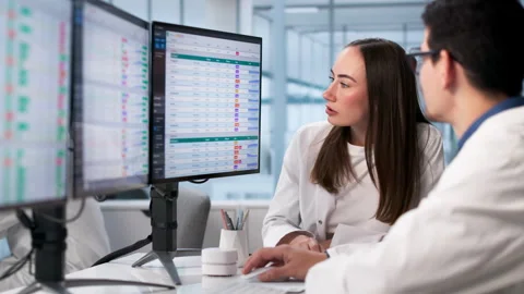Diverse Clinicians Analyzing Medical Data Using Computers Stock Footage 328710732