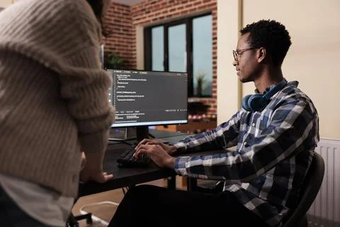 Diverse cloud programers using computer to write code Stock Photos