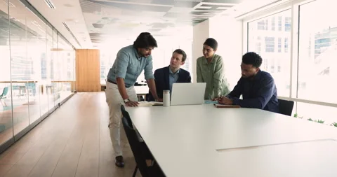 Diverse colleagues analyze data looks at laptop screen Stock Footage 266638329