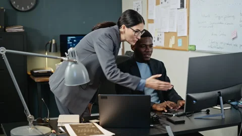Diverse Colleagues Analyzing Cybersecurity on Computer Screen Stock Footage 346814999