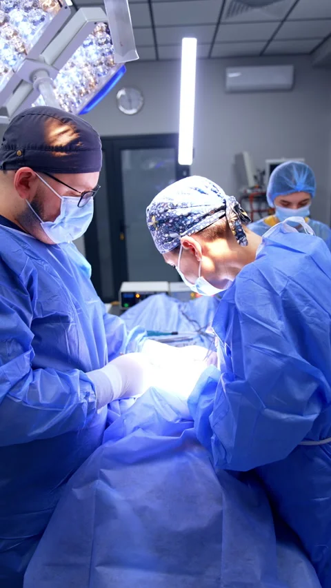 Diverse colleagues cooperate at surgery.  Stock Footage 304281968