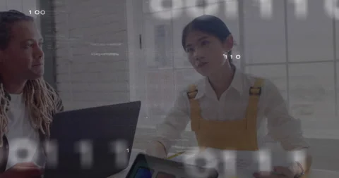 Diverse colleagues discussing work at office with binary code animation overlay Stock Footage 303584751