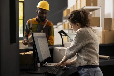 Diverse colleagues ensuring quality control for goods shipment Stock Photos