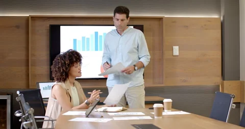 Diverse colleagues receiving report, comparing charts and annotating tablet Stock Footage 311566726