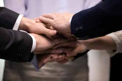 Diverse colleagues stack hands showing support at work Stock Photos