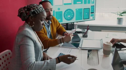 Diverse Colleagues Studying Presentation Slides at Marketing Meeting Video stock 276198310