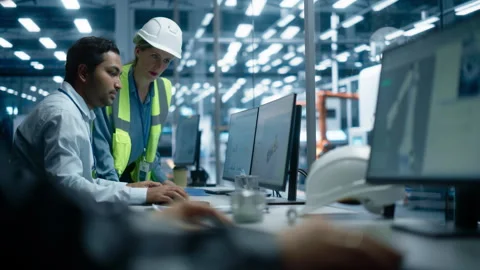 Diverse Colleagues Using Computer At Autonomous Factory Stock Footage 260696632