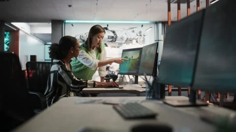 Diverse Colleagues Using Computer In GameDev Office Stock Footage 255796096