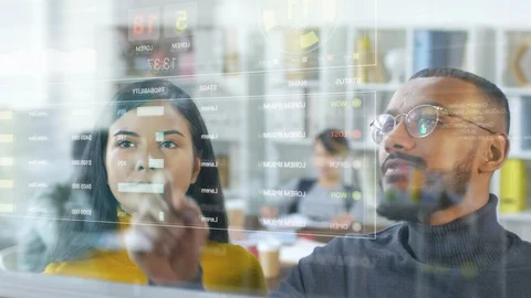 Diverse Colleagues Using Futuristic Virtual Screen in Office Stock Footage