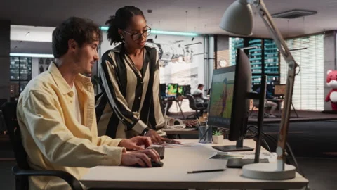 Diverse Colleagues Using PC In Game Development Office Stock Footage 255795157