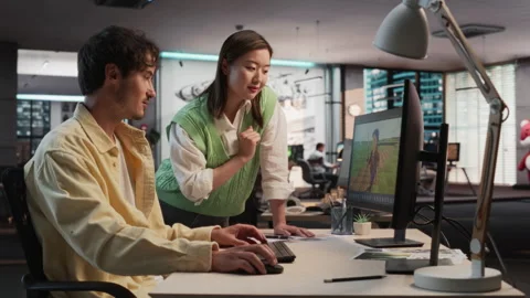 Diverse Colleagues Using PC In Game Development Office Stock Footage 255795170